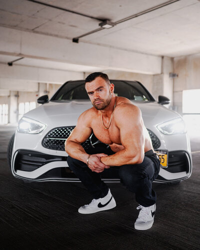 Posing with his new car during a parking garage portrait session in downtown Buffalo, NY.