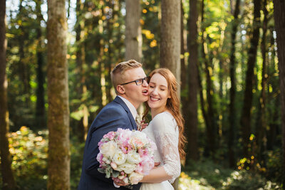 couple being goofy and silly with each other after wedding ceremony