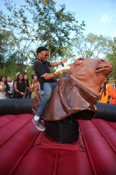 man riding mechanical bull