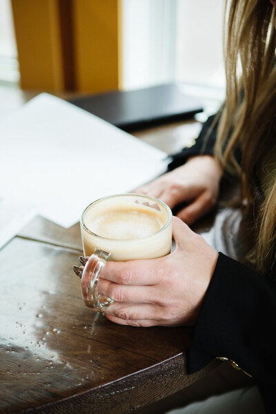 Southern Alberta Realtor Tamara Rzan holding a cup of coffee