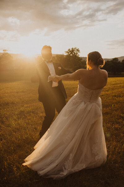 Bride and Groom dance outdoors in field