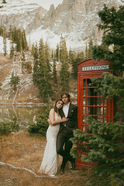 A couple exiting their wedding ceremony, cheering and dancing with their family and friends.