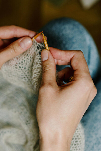 Closeup of knitting held in a person's lap as they work.