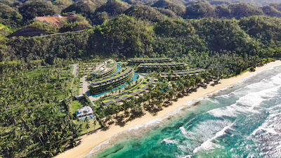 Aerial view of a coastal community surrounded by greenery in Las Terrenas