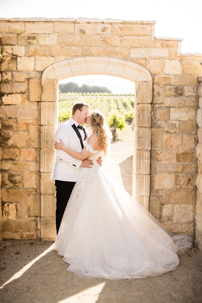 A couple embracing in the architecture at Sunstone Villa