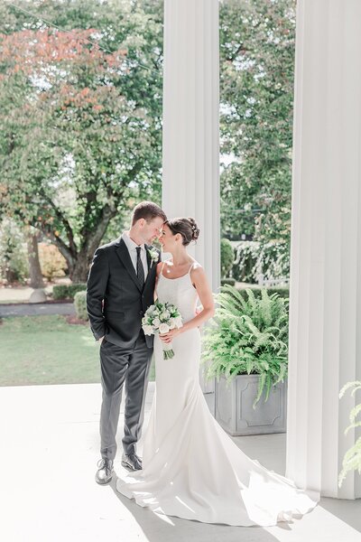 bride and groom embraced with foreheads touching