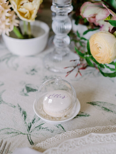 Personalized macaron place card inside a mini glass cloche for wedding at Bois Dore Mansion in Newport, Rhode Island
