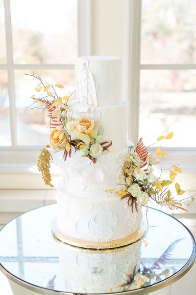 Unique textured wedding cake with yellow flowers