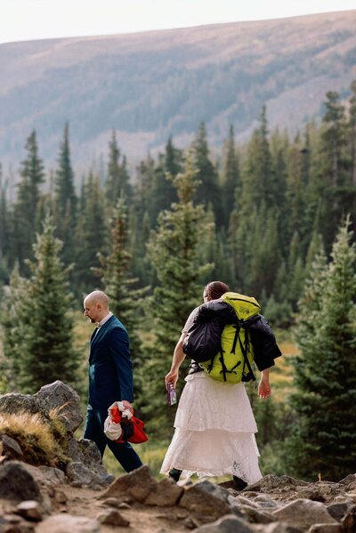 Couple hikes during Colorado sunrise hiking elopement.