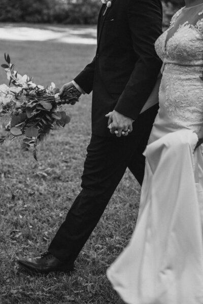 Bride and groom feet as they walk into the distance.