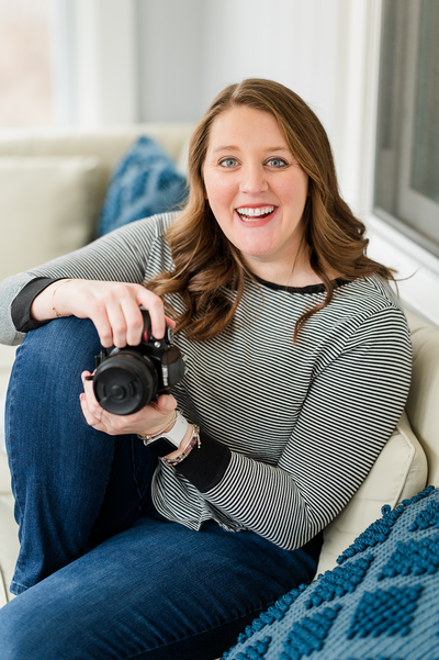 Best newborn photographer in Westwood, MA holding camera