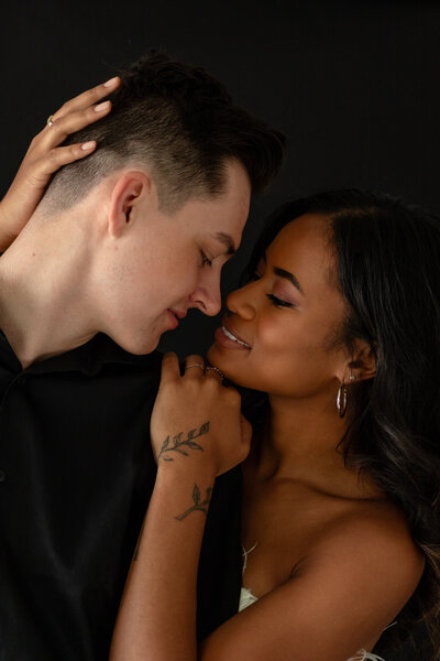 A tattooed couple laughing during their Springfield, MO elopement, captured by Chelsea Stanford