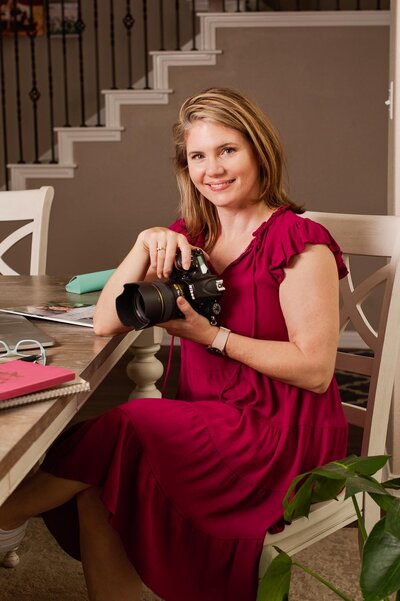Photo of a woman with a camera wearing a red dress - photographed by Austin TX based photographer Lydia Teague