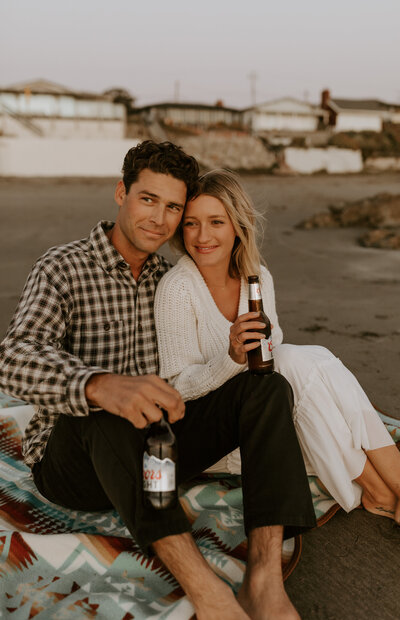 Couple cuddling on the beach together