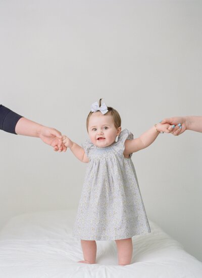 Smiling child during milestone mini session in bright, neutral studio in Fisher IL