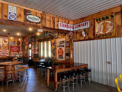 A wood-fired pizza with fresh toppings paired with a craft beer brewed in-house, served at Sawmill Pizza & Brew Shed in Echo Valley.