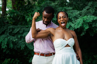 A person touches their partner's flexed bicep in disbelief at the large size
