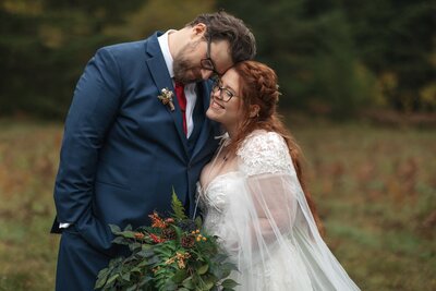 A wedding couple hold eachother close after just exchanging their vows in Silver Falls State Park in Oregon