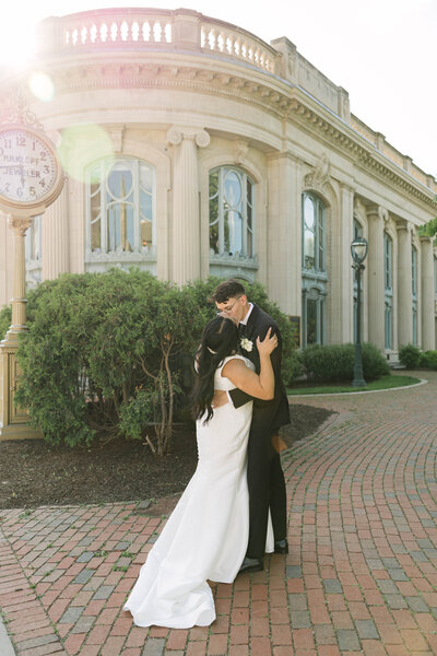 A timeless and elegant wedding portrait of the bride and groom outside the Milwaukee Historical Society in downtown Milwaukee. Captured by Alexia Rodriquez, a luxury wedding photographer known for refined, editorial storytelling with a personal touch.