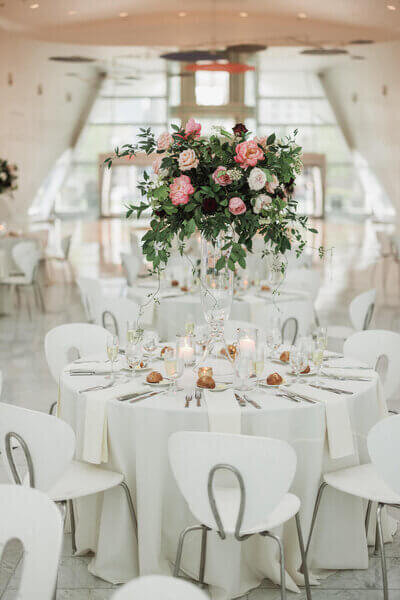 Tall floral centerpiece on elegant table design set up by Dream Weddings WI, wedding planners in milwaukee, in the Milwaukee Art Museum.