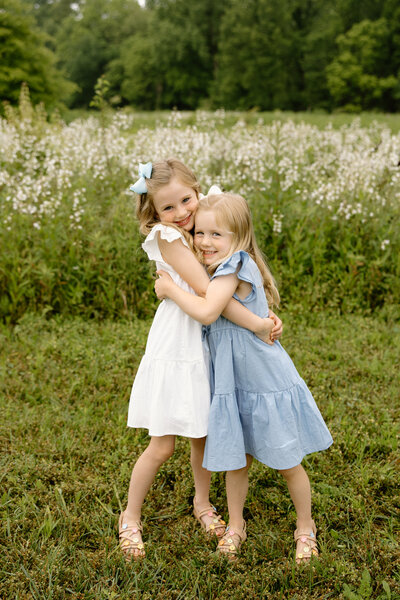 Sisters hugging each other during summer Indianapolis family photos