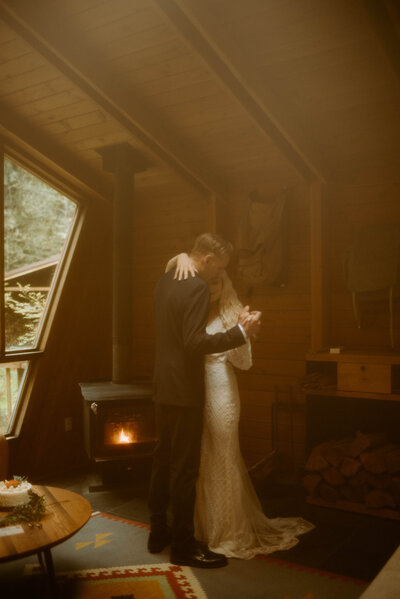 Couple eloping in Washington's slow dancing after their ceremony in their airbnb