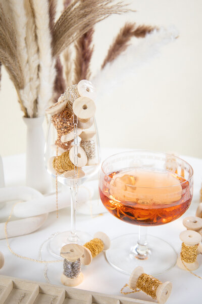 Permanent bracelet welding in progress on wrist with gold chains.