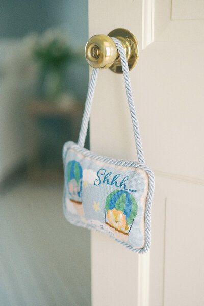 a personalized door hanger for a baby nursery