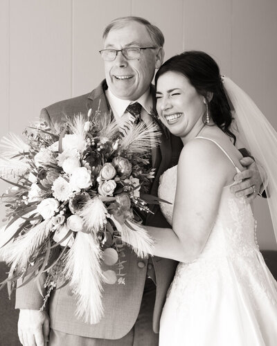 Bride hugging her dad with tears of joy during their first look