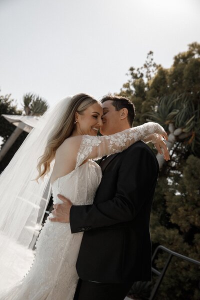 groom kisses bride after wedding in san diego