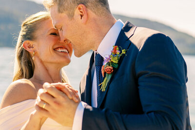 Joyful bride and groom sharing a romantic moment during their wedding day, captured by Joseph Mayden in a bright, natural light outdoor setting.