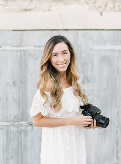 Shelby smiling while holding a camera