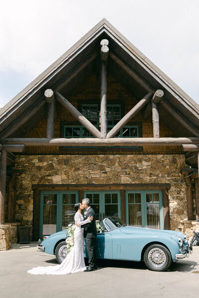 Bride and groom kissing outside Colorado wedding venue