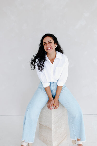 Photographer, Teresa Williams smiles in white blouse