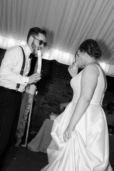 A newlywed couple dancing at a wedding reception together