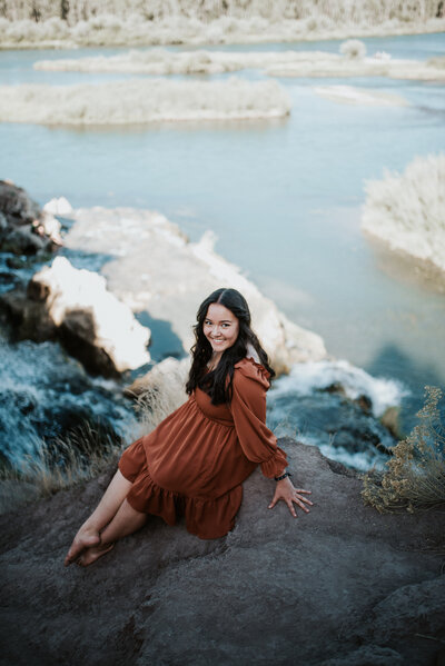 smiling young woman posing for her Idaho senior photographer