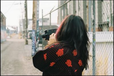 Steph with camera and hair flip