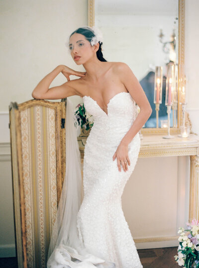 a wedding photo of a bride posing in her white dress at villa aura del lago