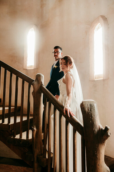 Bride and groom walking up stairs together during their Jacksonville, Florida wedding.