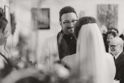 Black and white photo of Bride and groom facing each other