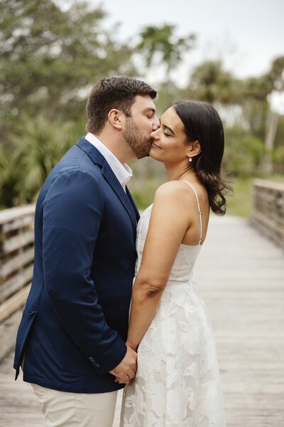 bride and groom share a kiss