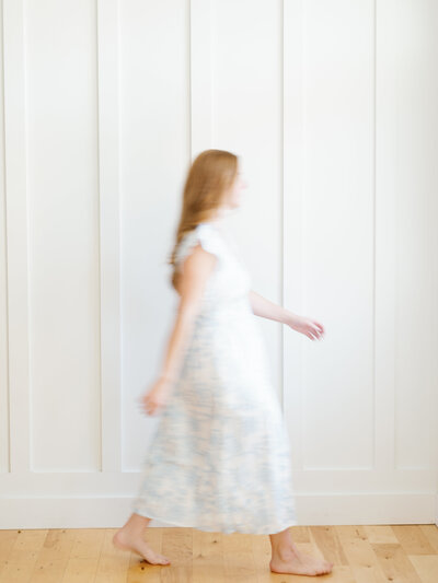 Amanda of Fleuritage walking gracefully in a floral dress, embodying calm, presence, and movement.