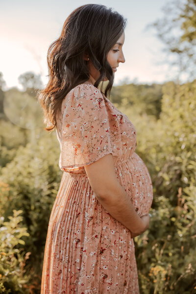 Pregnant women cradling her belly during maternity session in Wheaton, IL