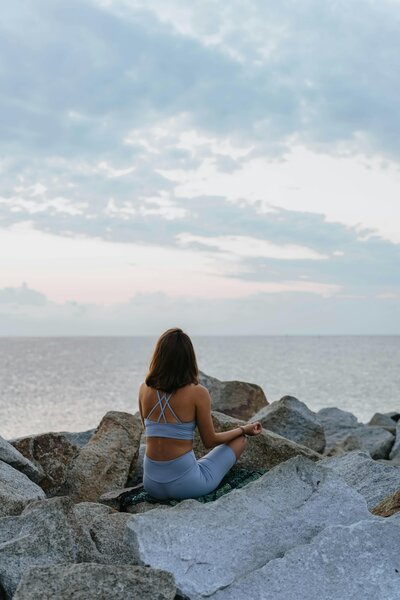 woman meditating on the beach