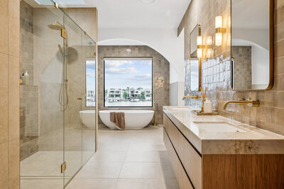 The Marisol home’s master bathroom, designed with a freestanding tub, arched mirrors, and handcrafted tiles for a Mediterranean-inspired aesthetic.