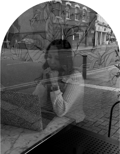 A smiling self portrait of a woman sitting with her laptop