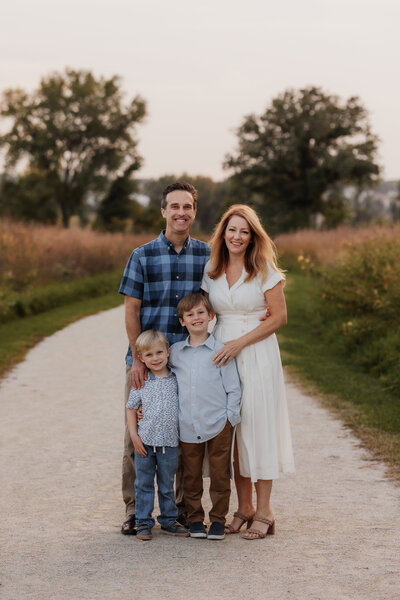 A portrait of a family on a gravel path.