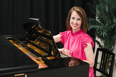 Brand photo of a music studio owner posing in the piano 