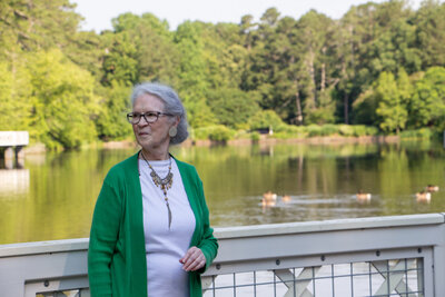 Female author and memoirs mentor standing on white bridge