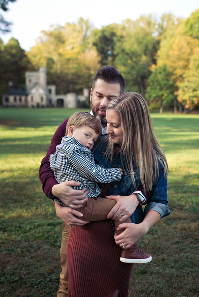 Family photography of mom, dad, and young boy.